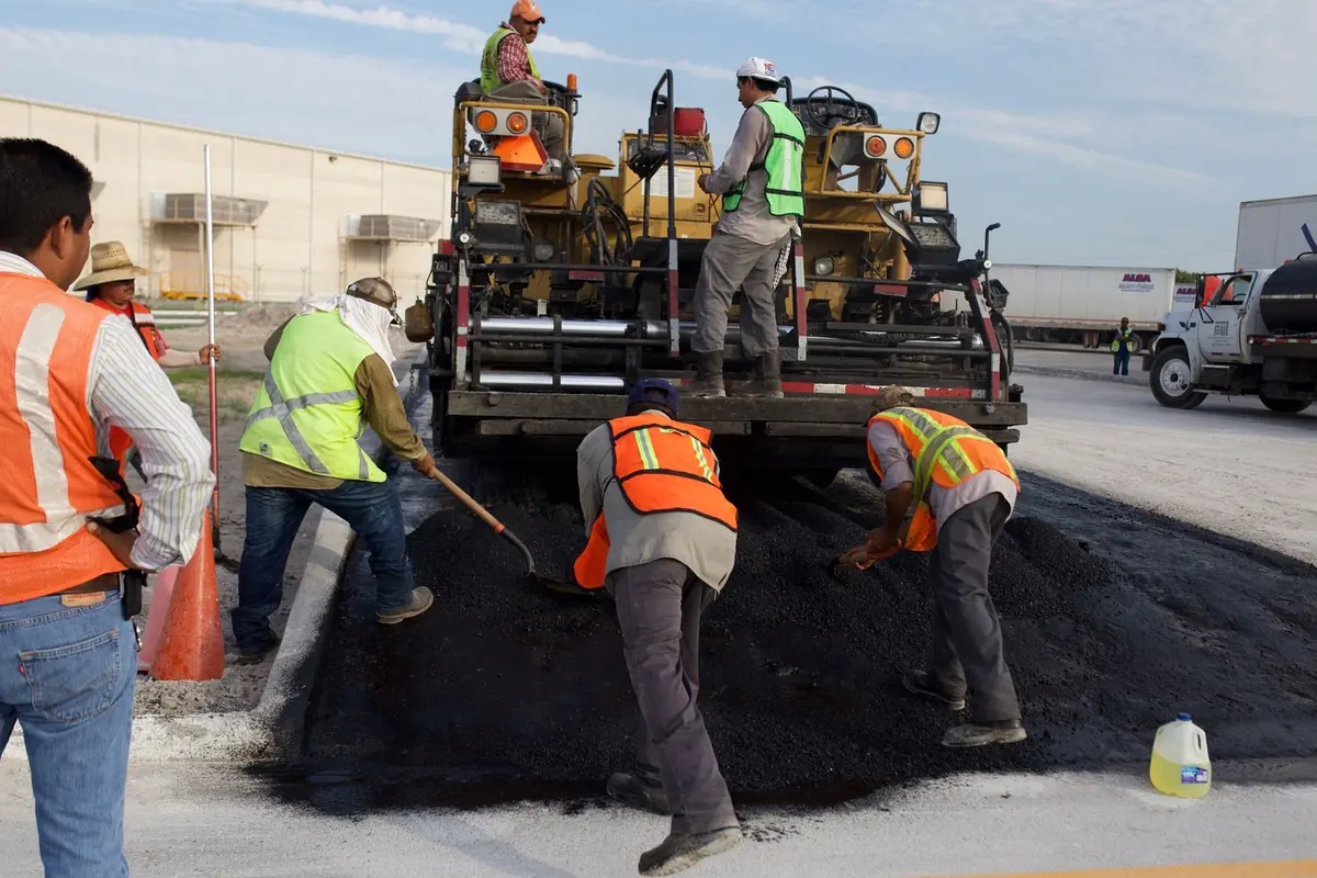 Paving crew laying asphalt